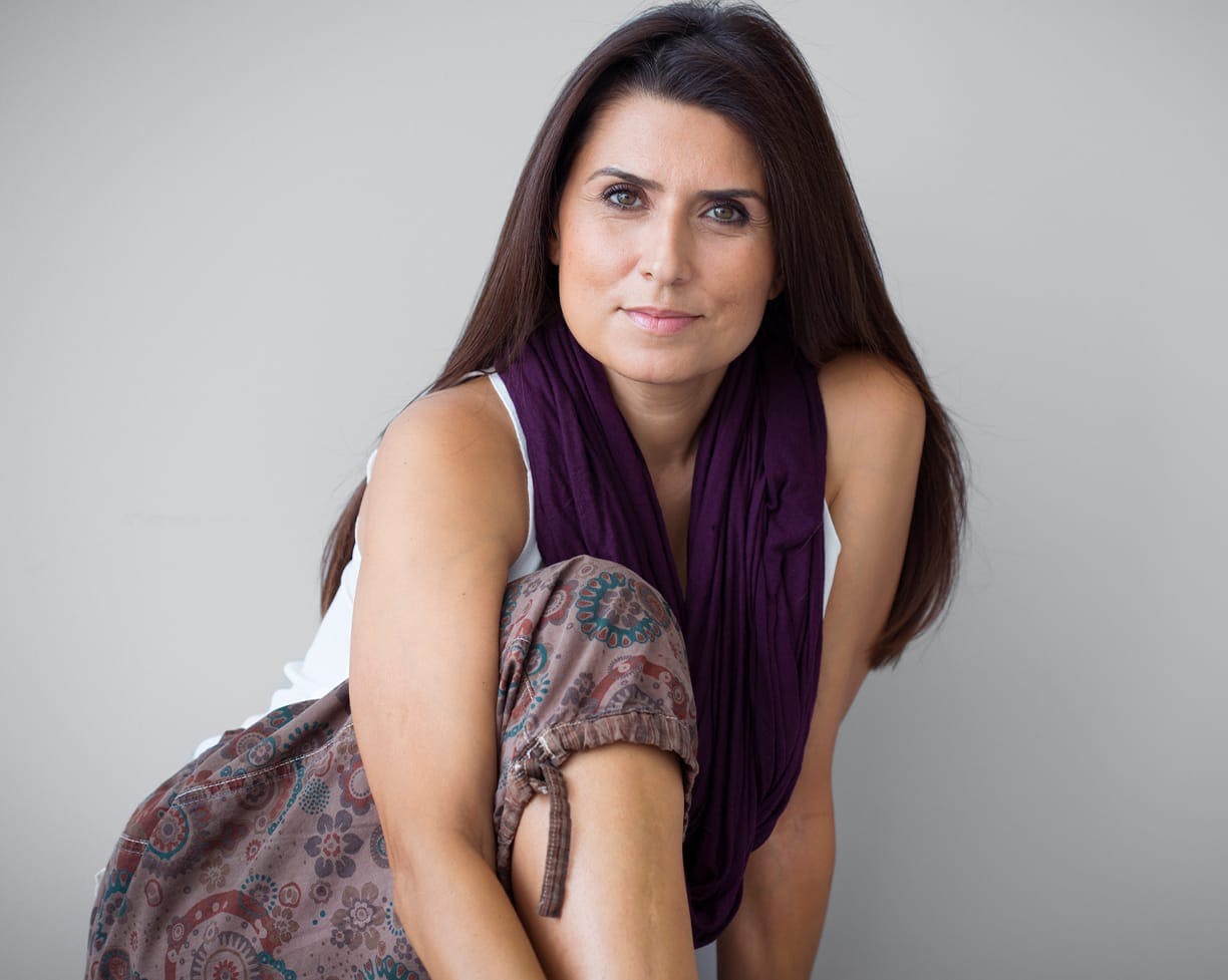 woman with straight brown hair sitting