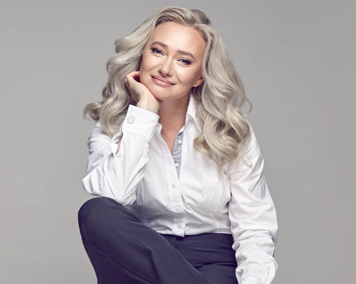 woman with grey hair in button down shirt