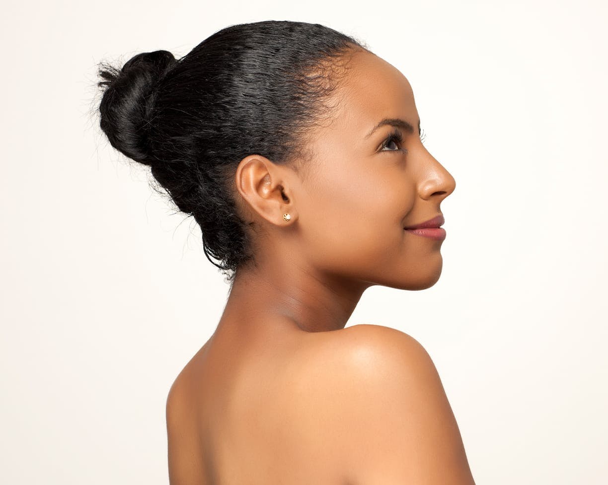 Woman looking to the side with her hair in a bun