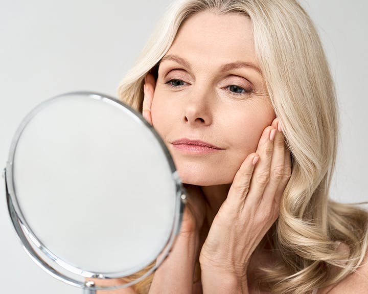 woman looking in mirror