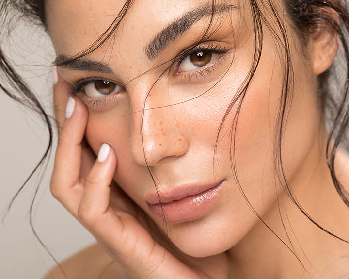 Woman with brown eyes and freckles on her nose