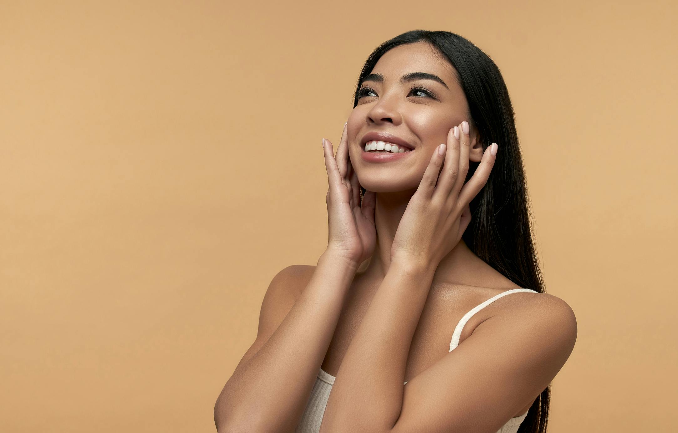 Woman touching her face and smiling