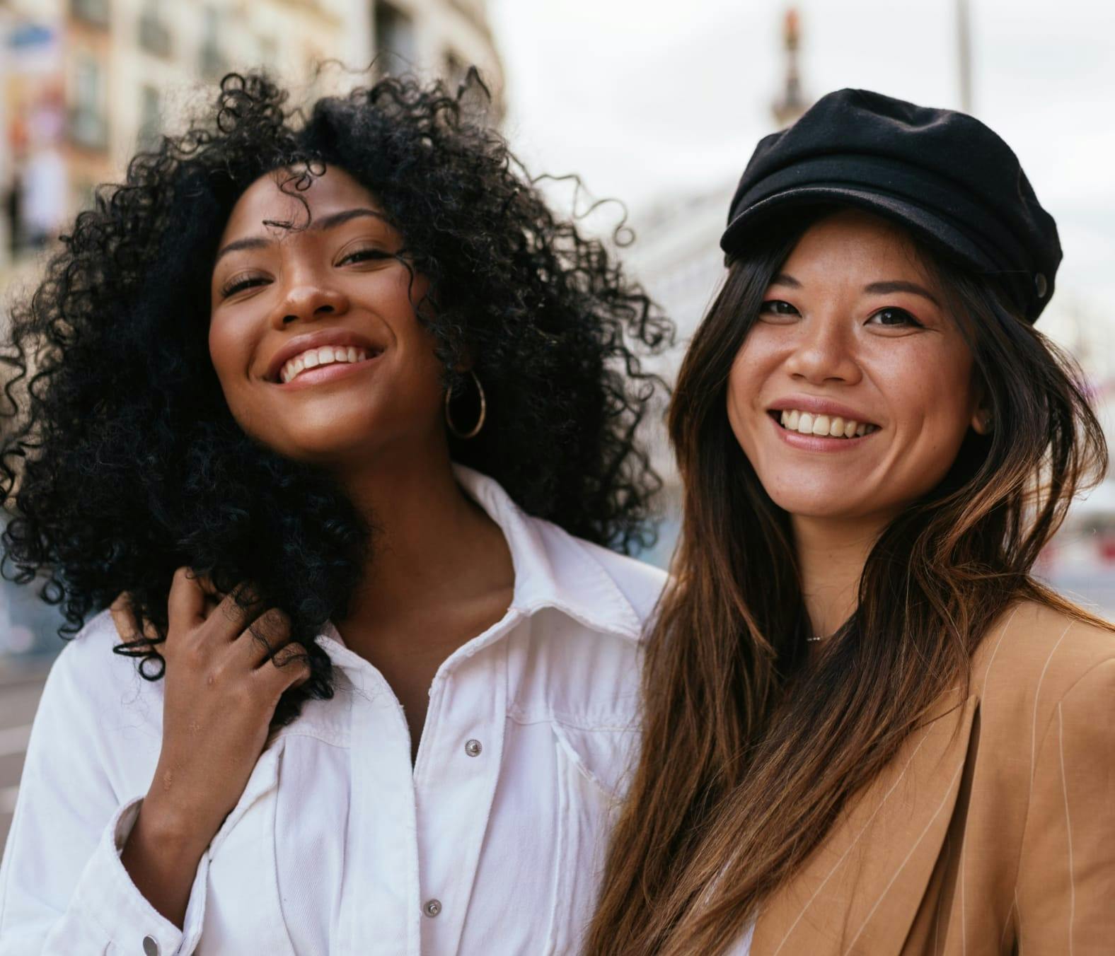 Two Happy Young Women in the City, Smiling into the Camera