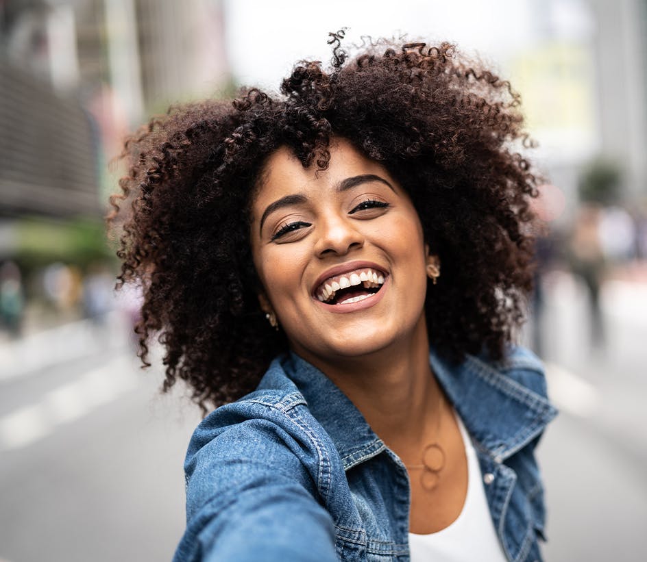 Woman without headache smiling in street