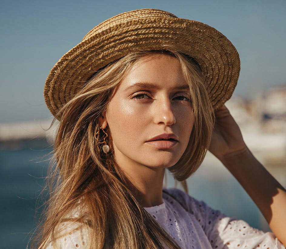 Blonde-haired woman with light brown hat