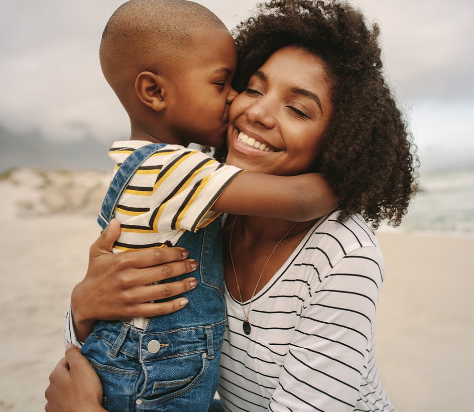 son giving mom a kiss