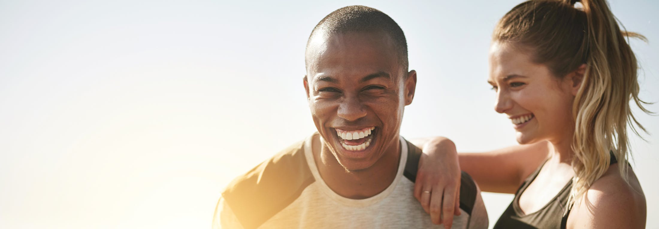 man and woman smiling outside