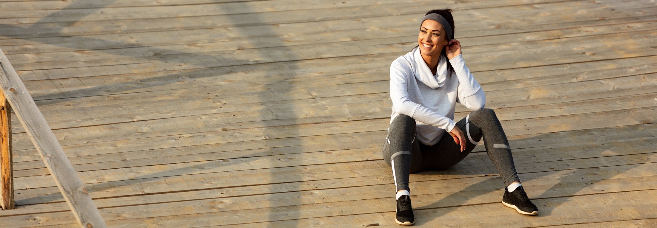 woman sitting on a boardwalk
