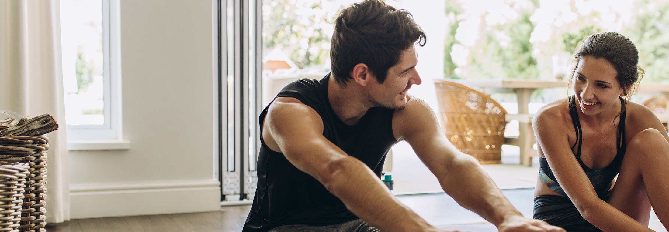 Man and woman stretching on yoga mats