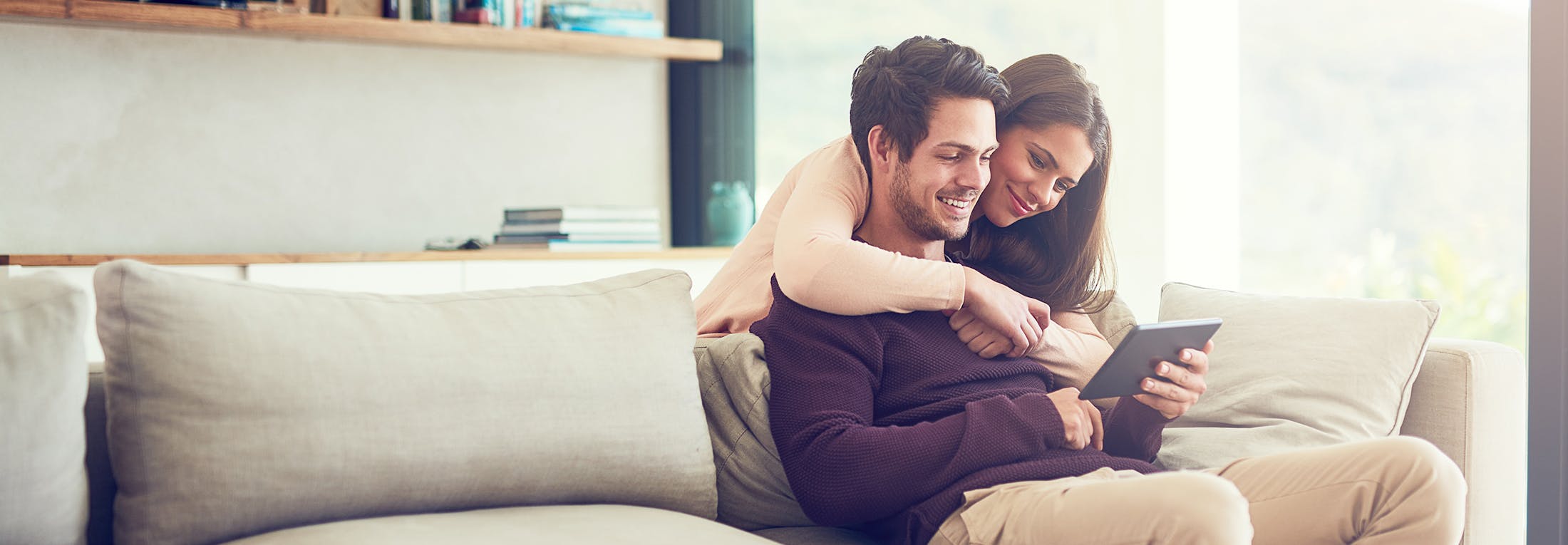 man and woman sitting on the couch