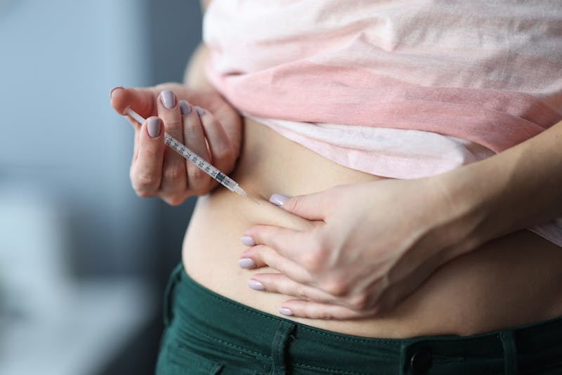 Woman using weight loss shot