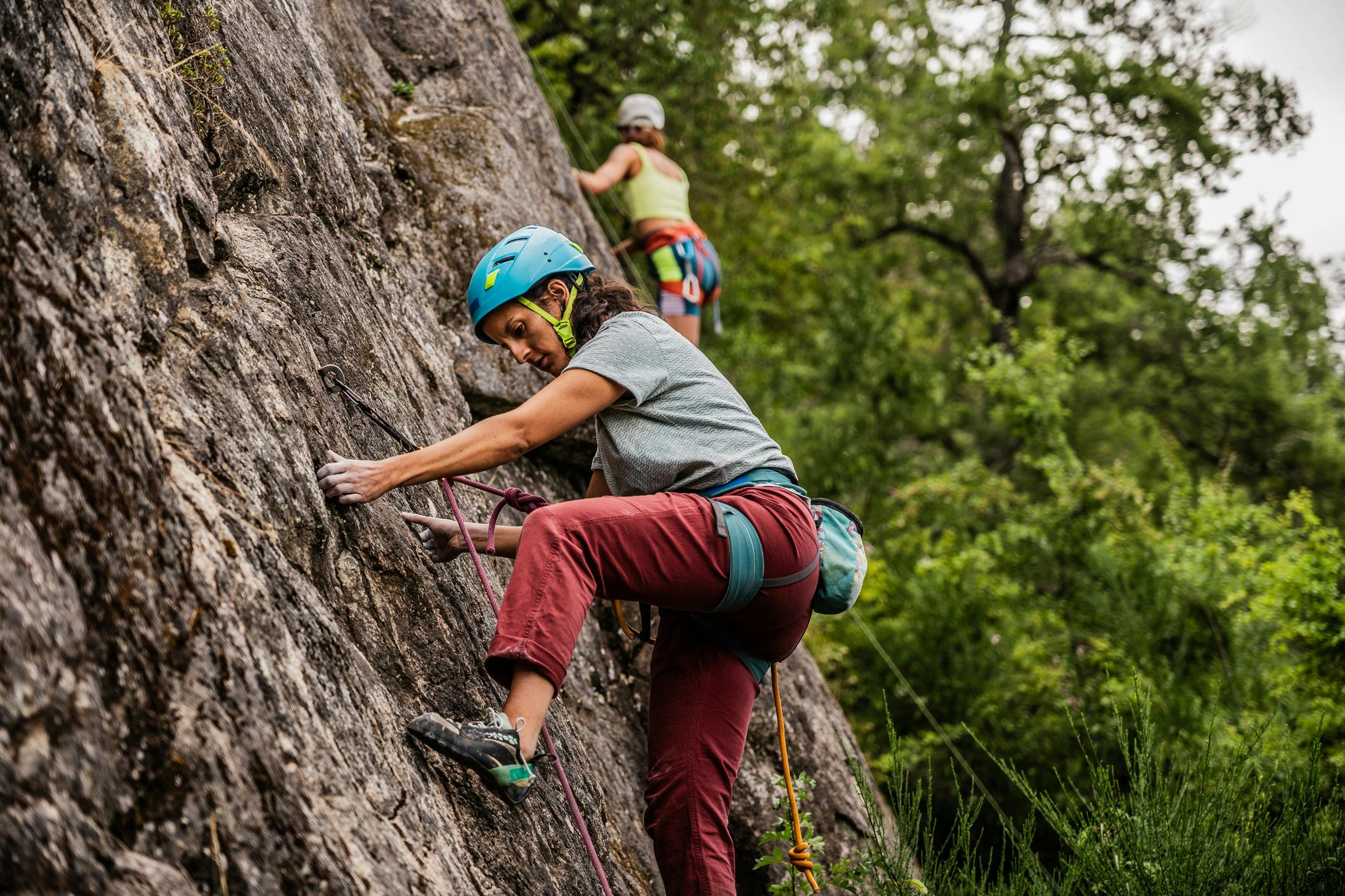 Two women rock climbing