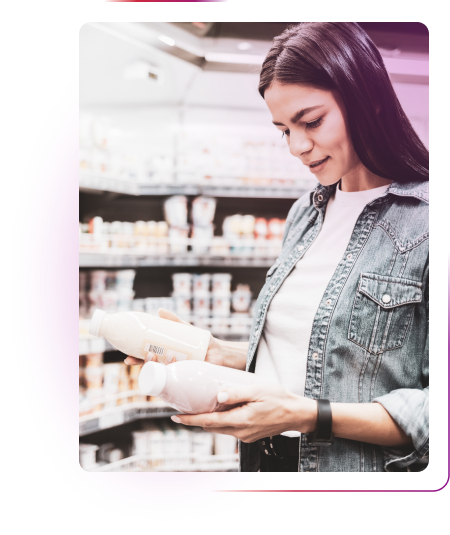 Woman comparing milky products in store