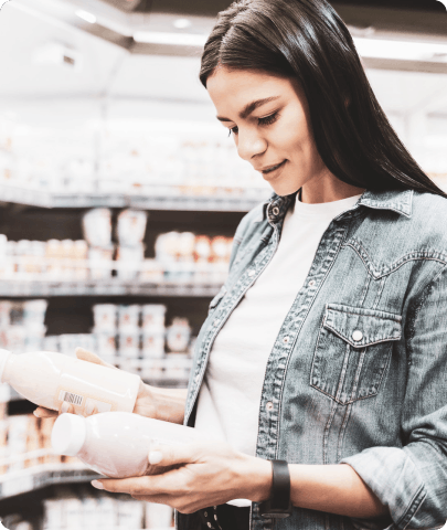 Woman comparing milk products in store