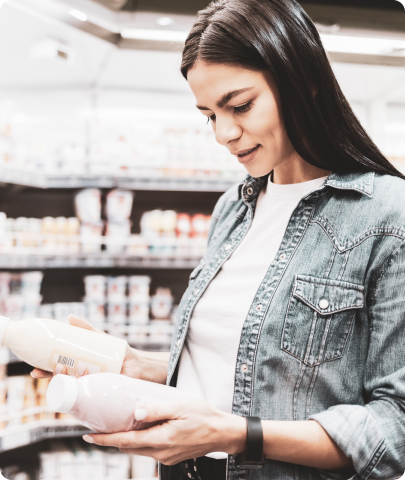 Woman comparing milk products in store