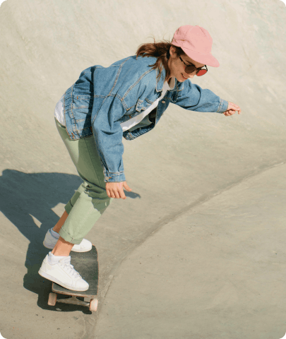A woman skillfully rides a skateboard down a ramp.