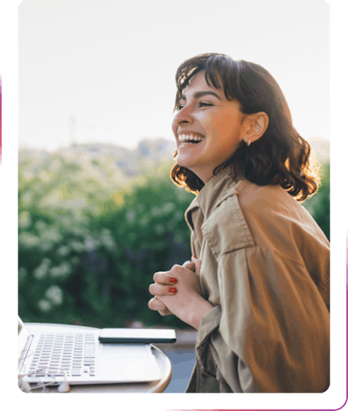 young women smiling and using laptop