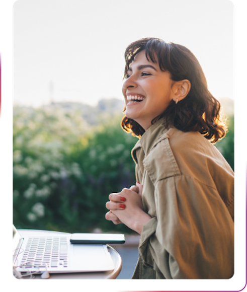 young women smiling and using laptop