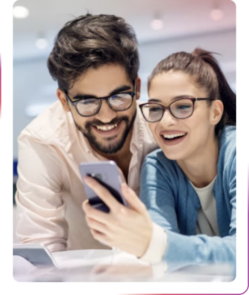young couple using a phone and smiling
