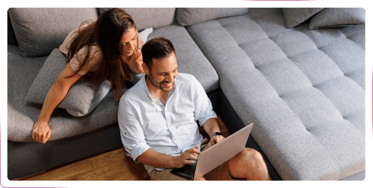 couple using laptop smiling