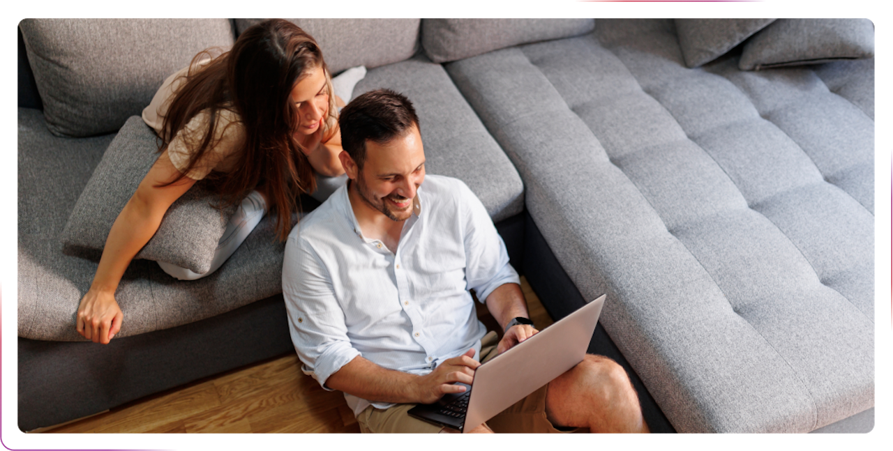 couple using laptop smiling