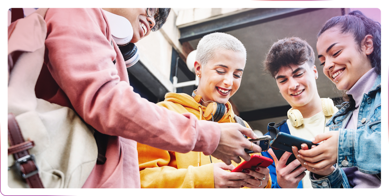 group of young people using phone and smiling