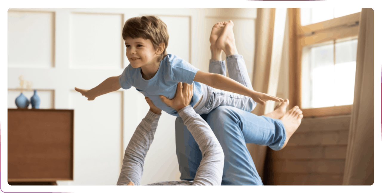 little boy smiling and playing with an adult