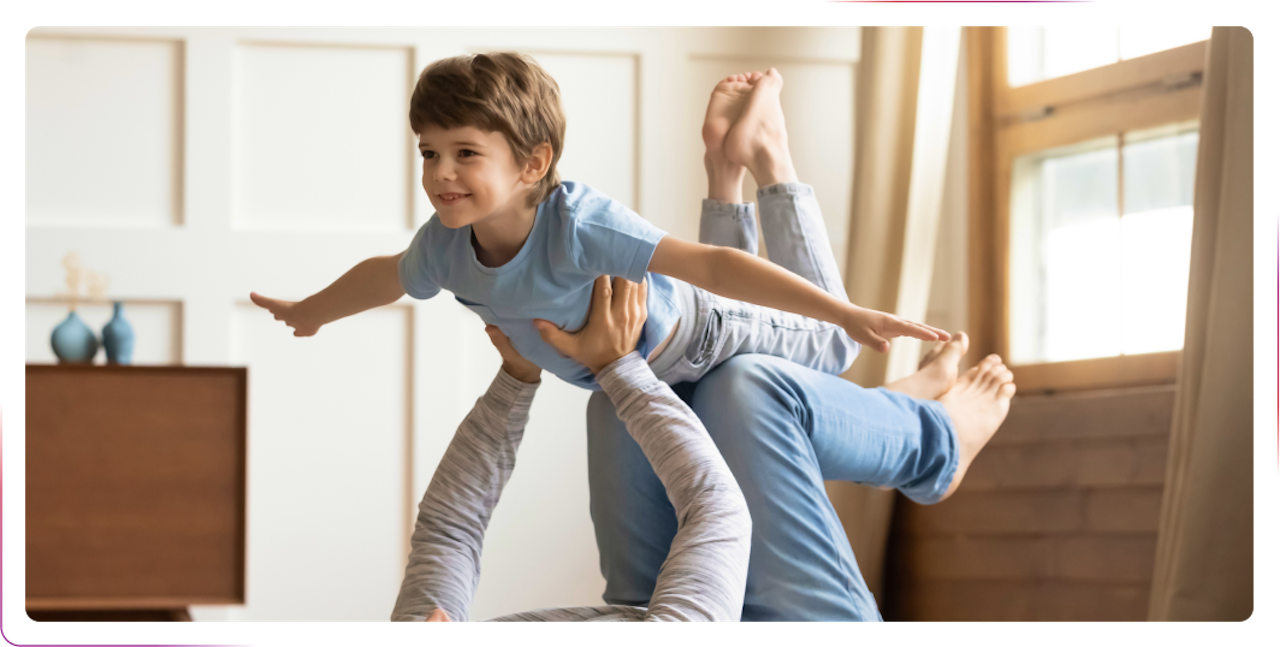 little boy smiling and playing with an adult