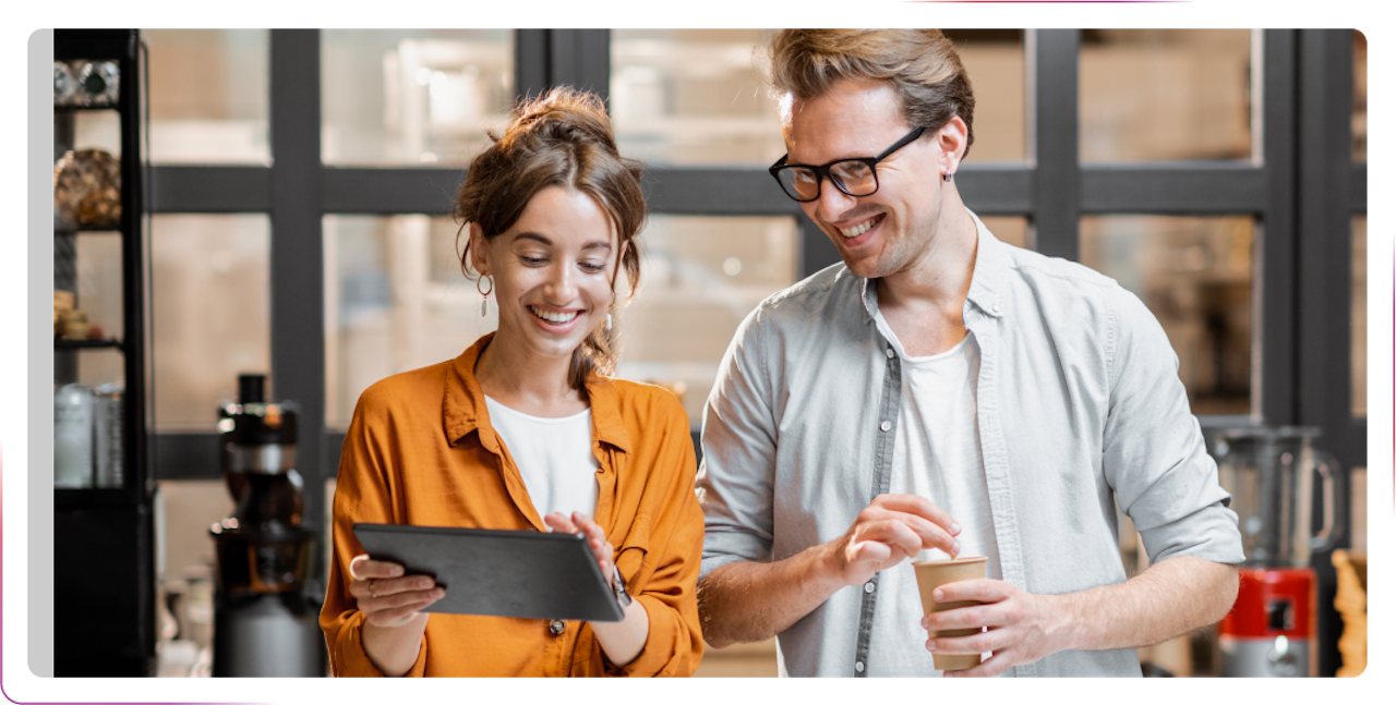 young people smiling and using tablet