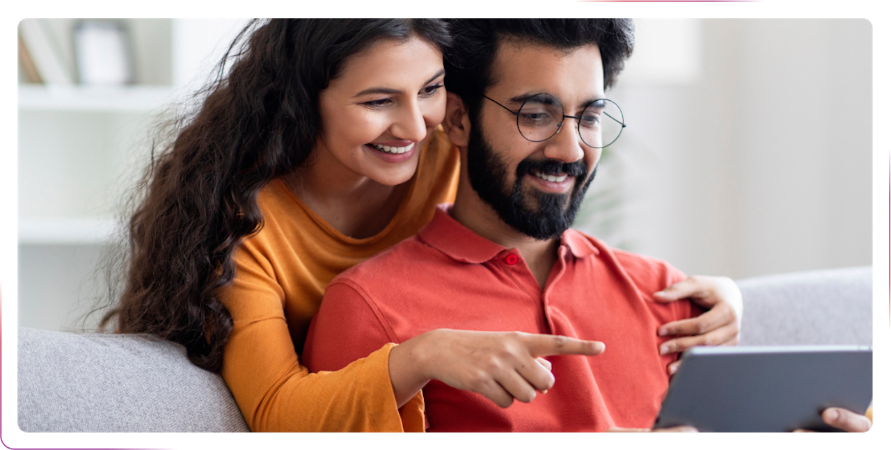couple using tablet and smiling