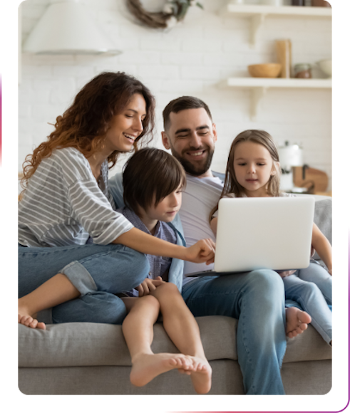 family using a laptop and smiling