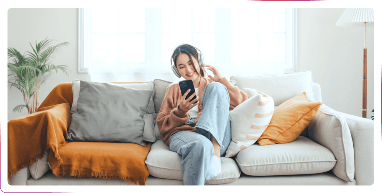 young girl sitting on the sofa and using phone