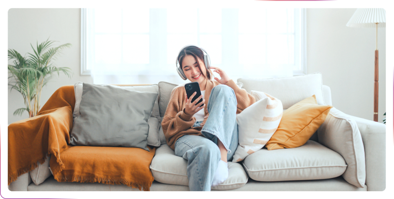 young girl sitting on the sofa and using phone