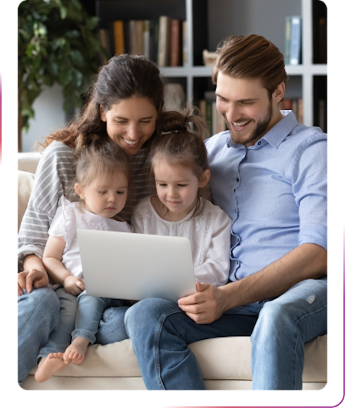 the family using laptop and smiling