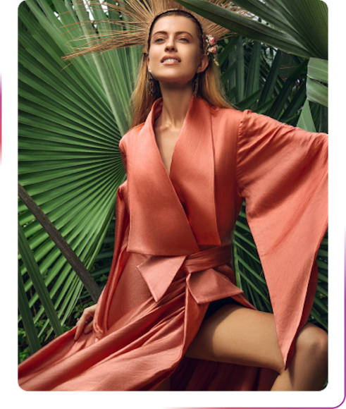 young woman posing next to the palm