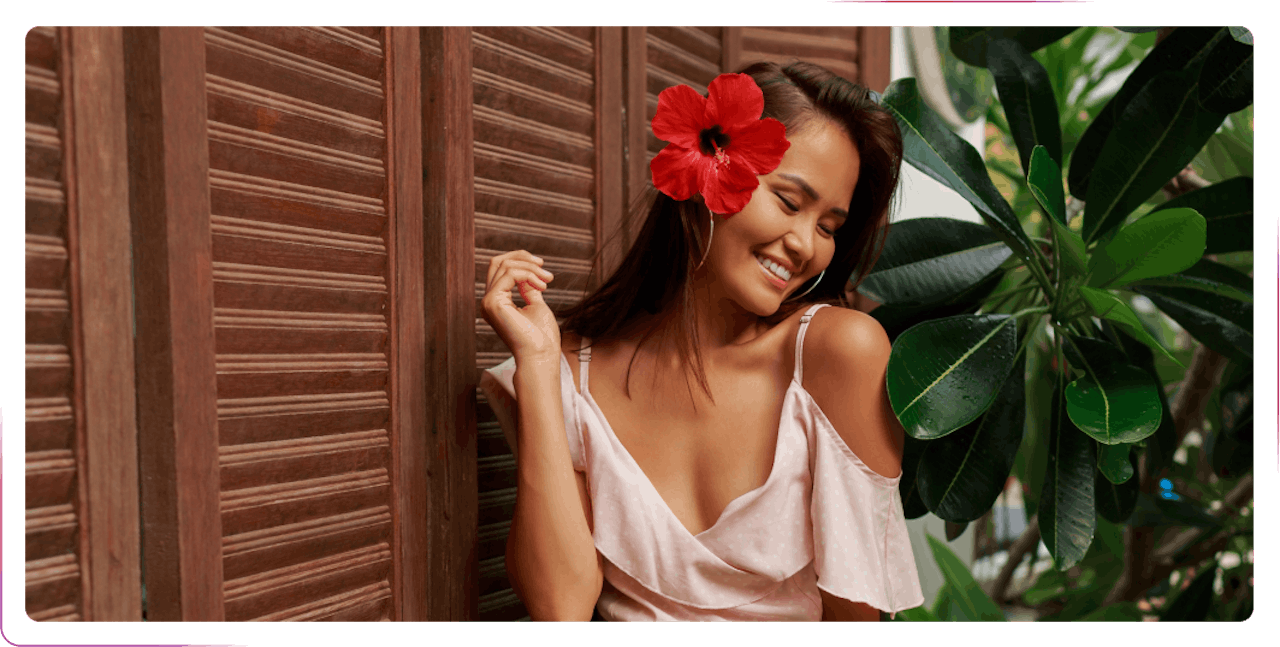 young woman smiling and wearing fresh flower