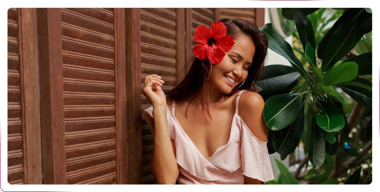 young woman smiling and wearing fresh flower