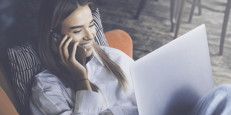 Woman talking on phone with laptop