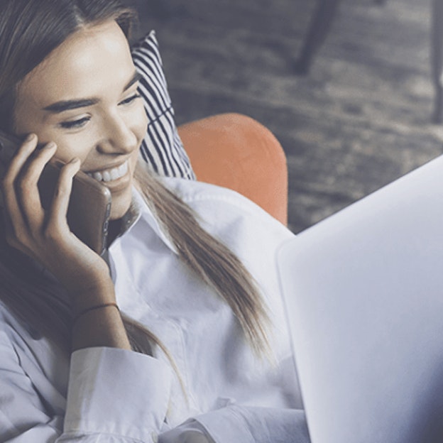 Woman talking on phone with laptop