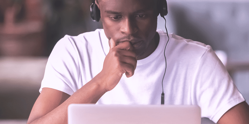 Man in headphones using laptop