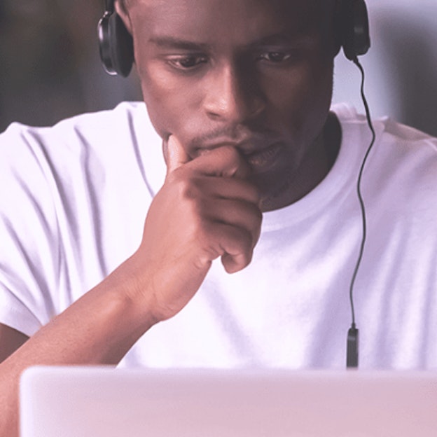 Man in headphones using laptop