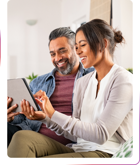 couple using tablet and smiling