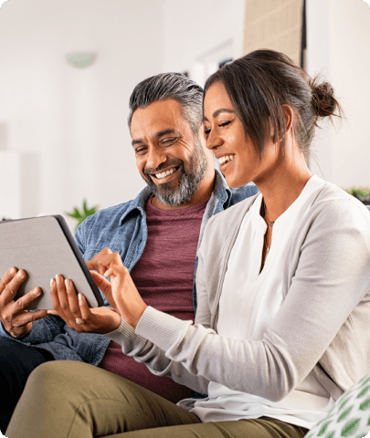 couple using tablet and smiling