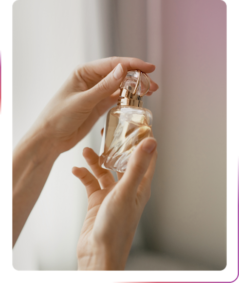 hands holding a bottle of perfume