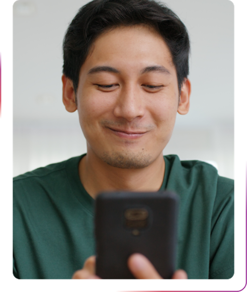 young man using mobile phone and smiling