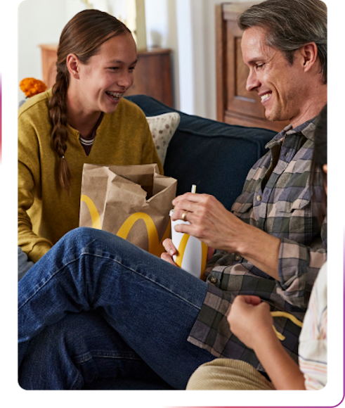 young couple having fun eating mcdolands food