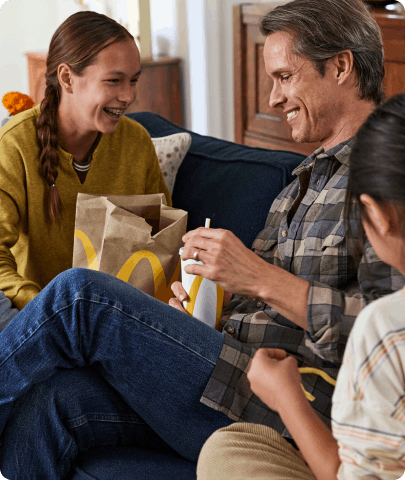young couple having fun smiling eating food from mcdolands