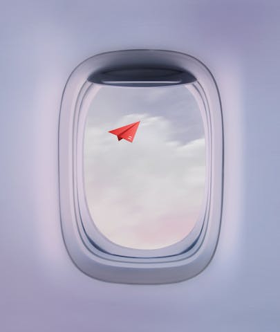 cover photo airplane window with paper airplane