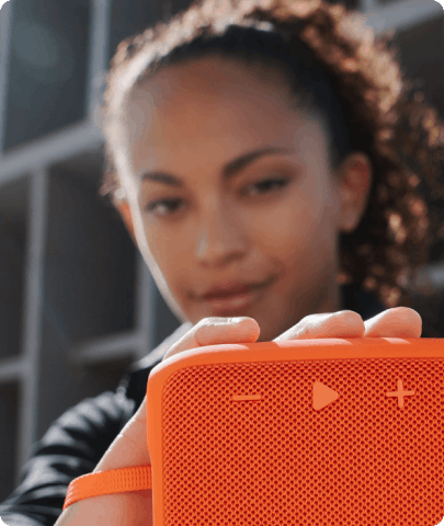 young girl holding orange loudspeaker