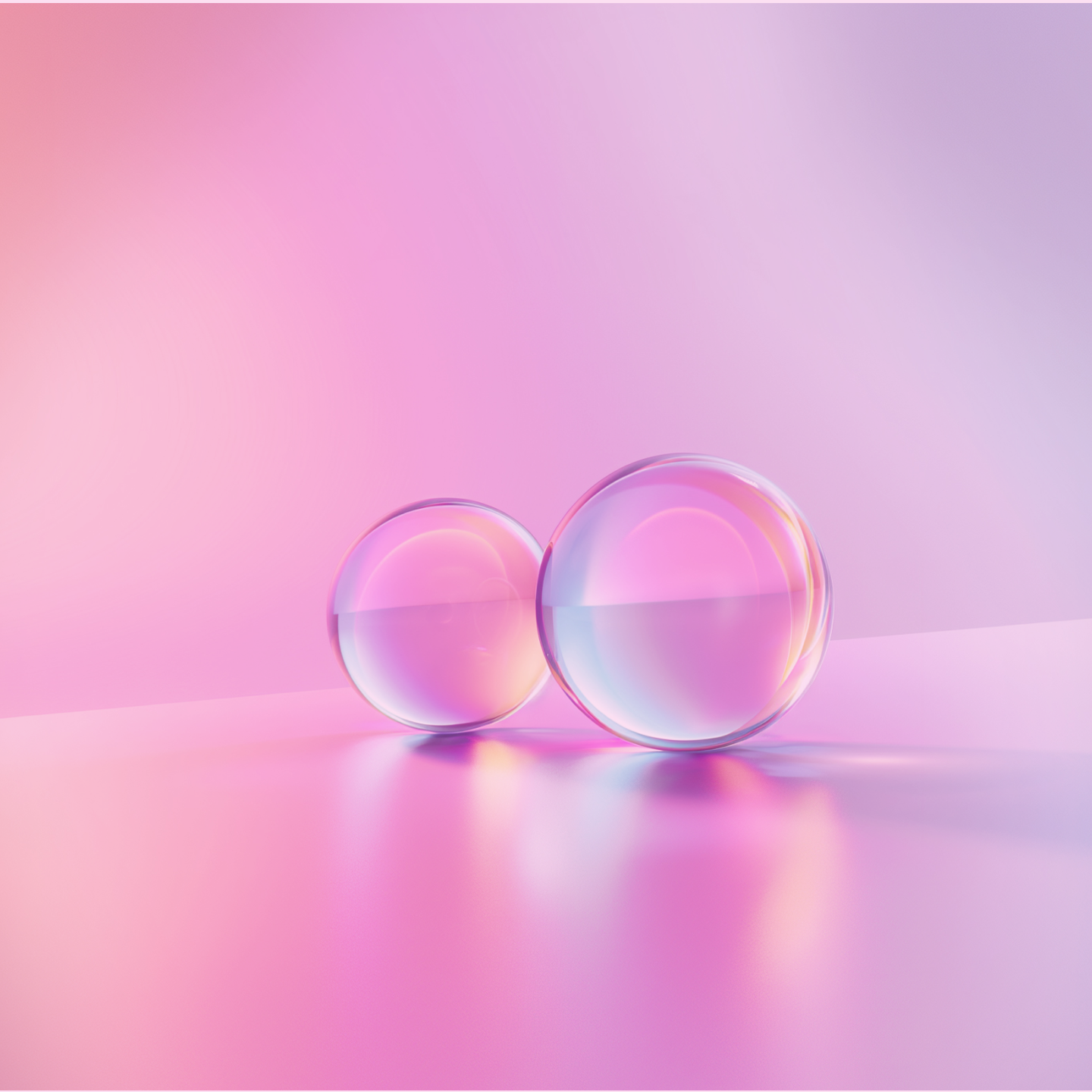 A pair of glass spheres set against a pink backdrop, showcasing a playful and colorful aesthetic.